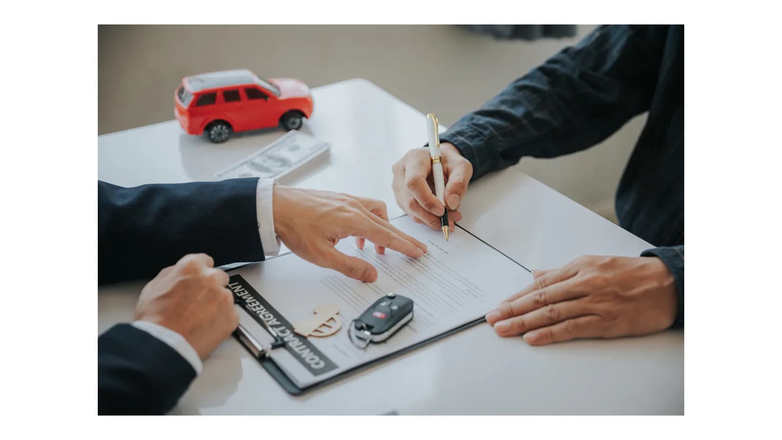 Oregon vehicle seller reviewing the signature area on a car title before a local junk-car pickup
