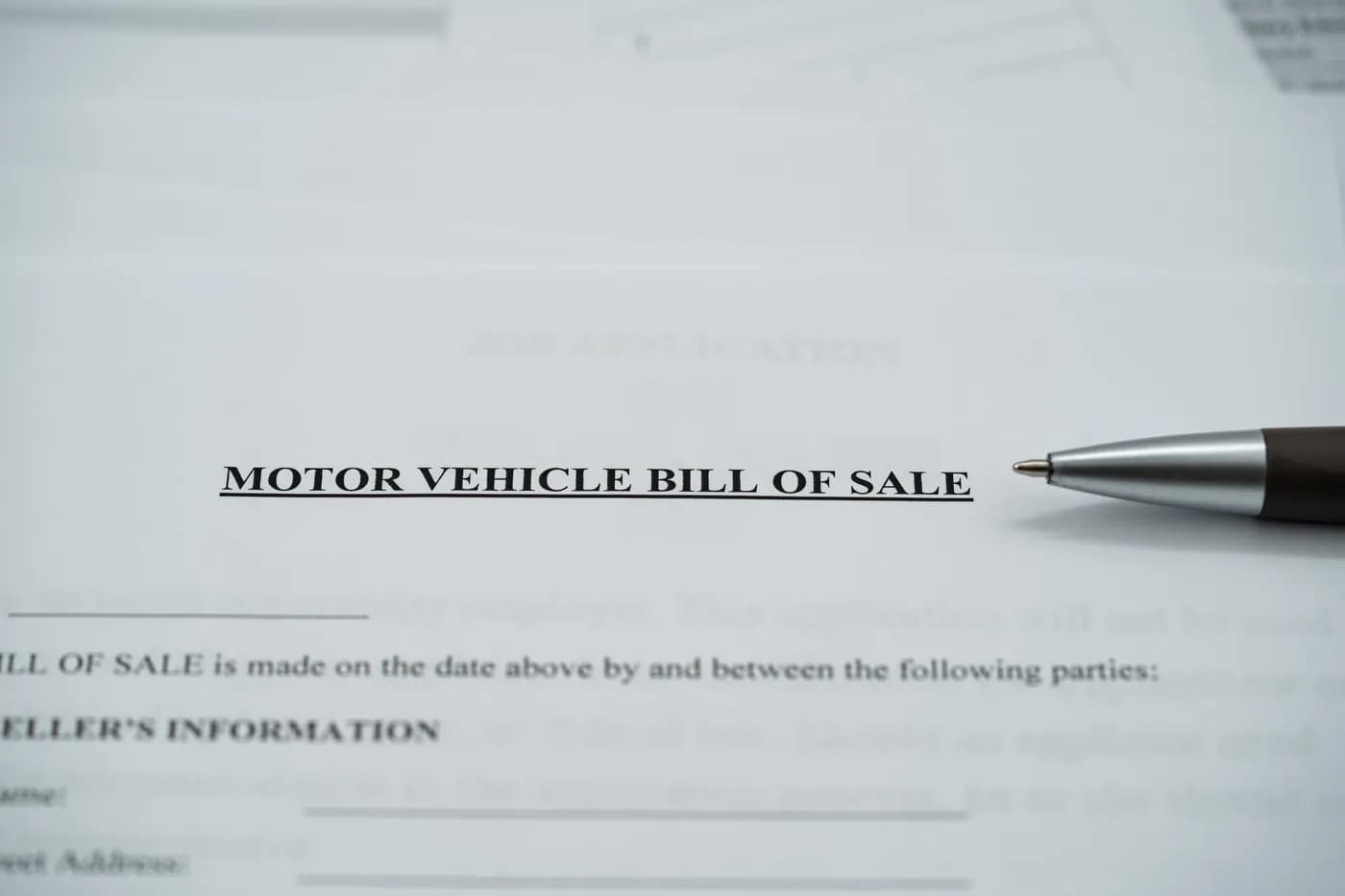 Vehicle bill of sale and pen prepared for an Oregon junk-car transaction